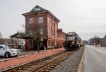 NS 5619 northbound with a local freight passing the ex-PRR red brick depot